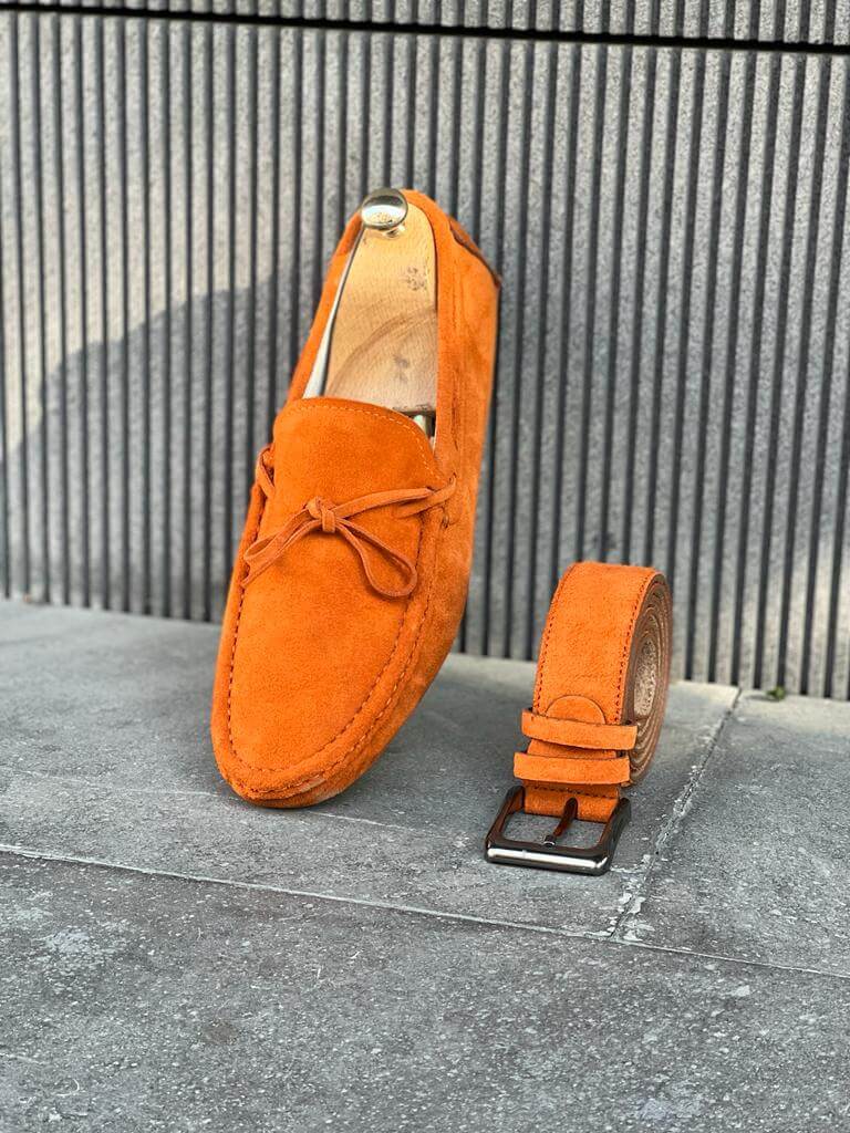 Bright orange leather casual loafers featuring a slip-on design and rubber soles, styled for vibrant spring and summer looks.