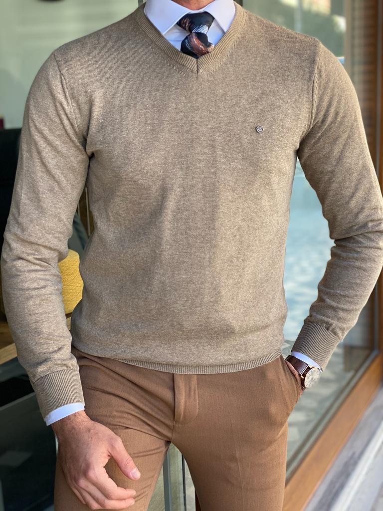 A slim fit beige knitwear sweater with a textured pattern. The sweater features a round neckline and long sleeves, providing a stylish and comfortable option for a casual or semi-formal look.