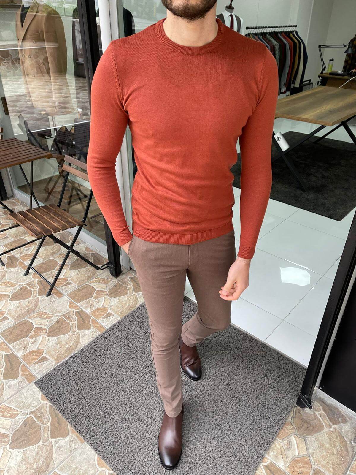 A cozy crewneck sweater in a textured tile pattern, featuring a blend of warm colors and a soft knit fabric."