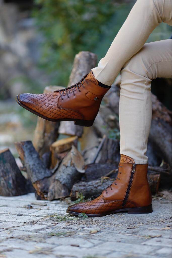 Wistman camel classic boots worn with cream trousers, highlighting the grid-patterned leather and clean finish.