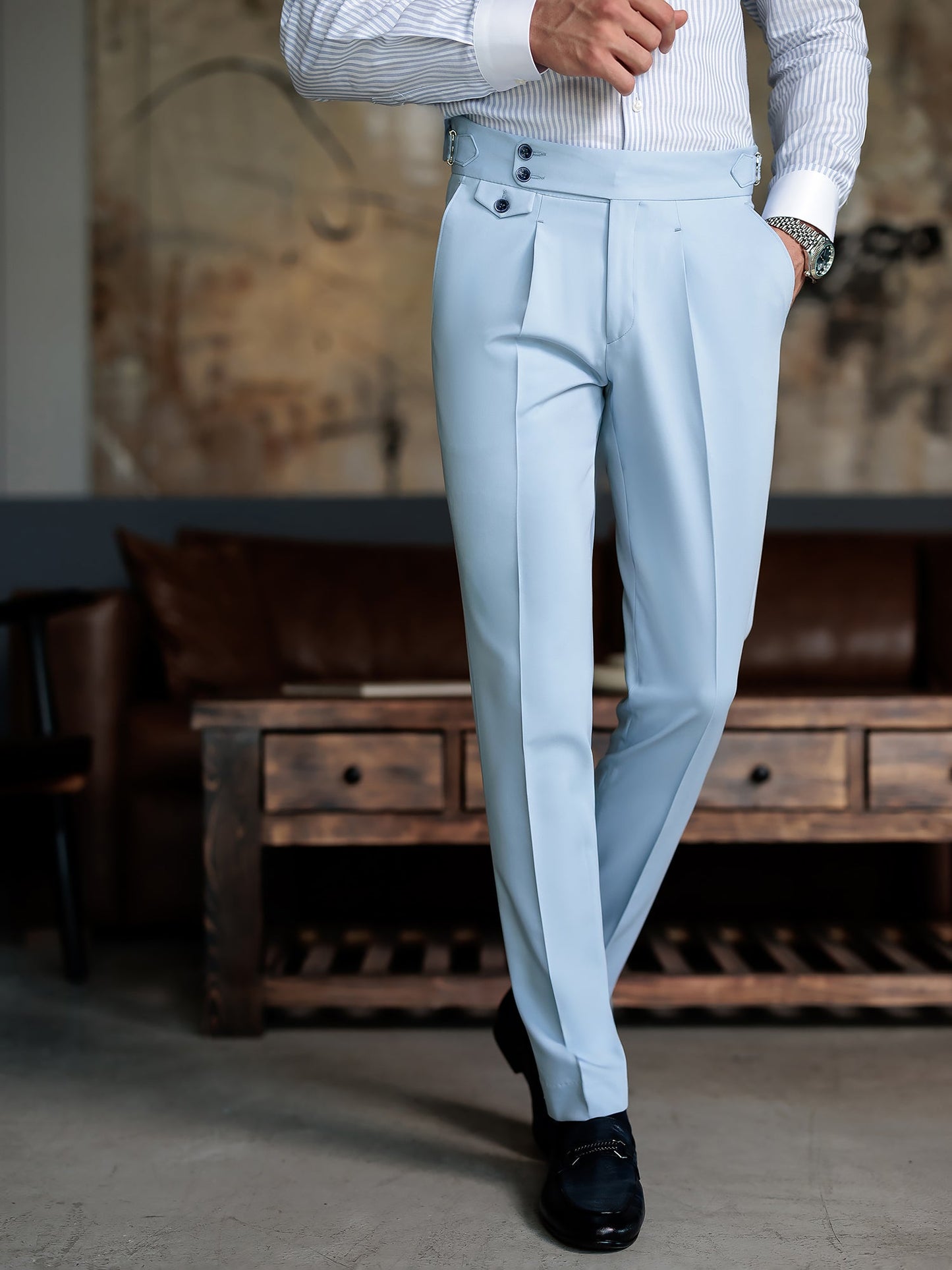 Men wearing a sky-blue double-breasted slim-fit suit with a white shirt and black tie, styled in a modern indoor setting.