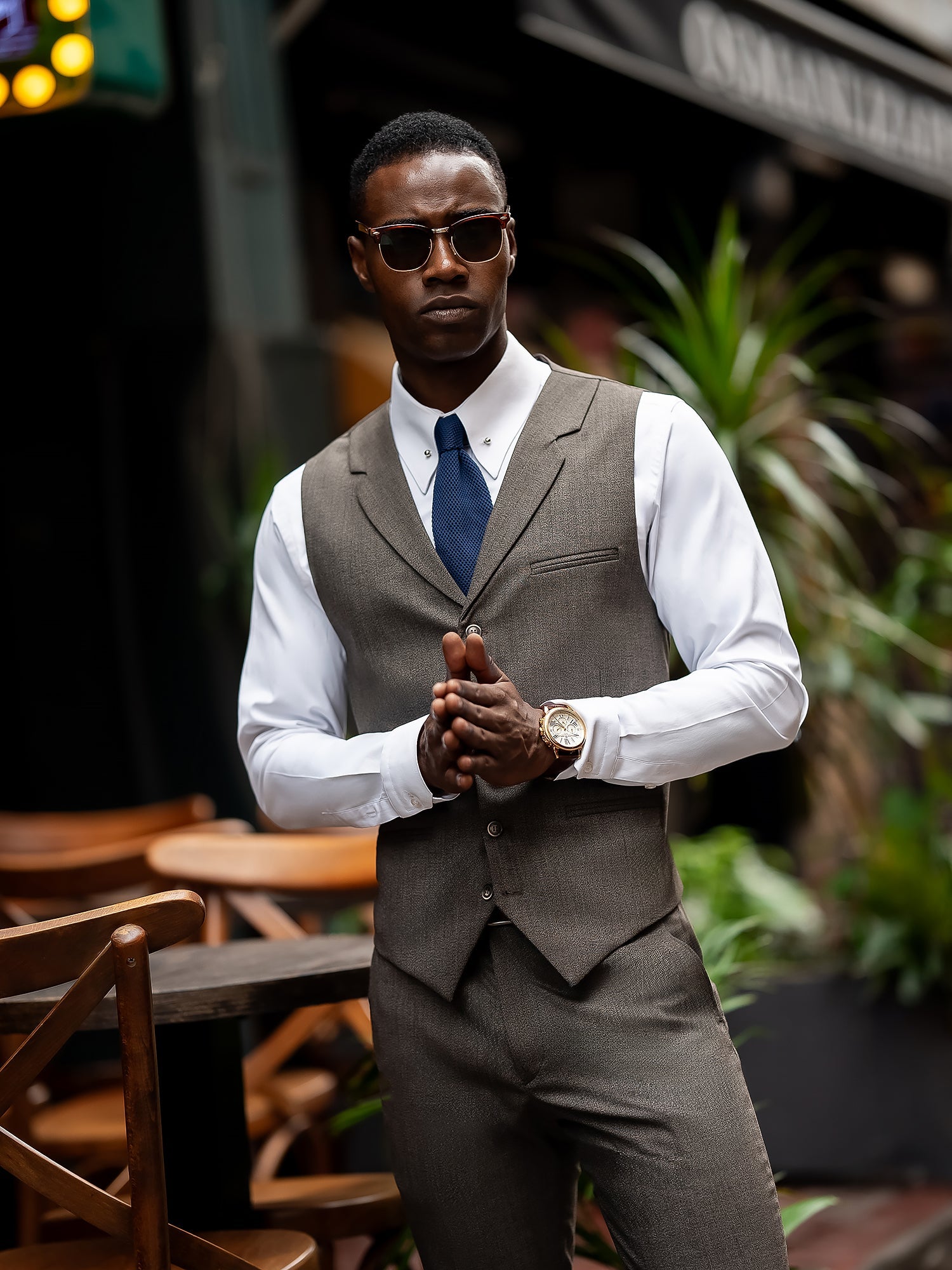 Men’s brown plaid slim-fit 3-piece suit with peak lapel blazer, matching vest and trousers, styled for formal and smart occasions with a modern tailored silhouette.