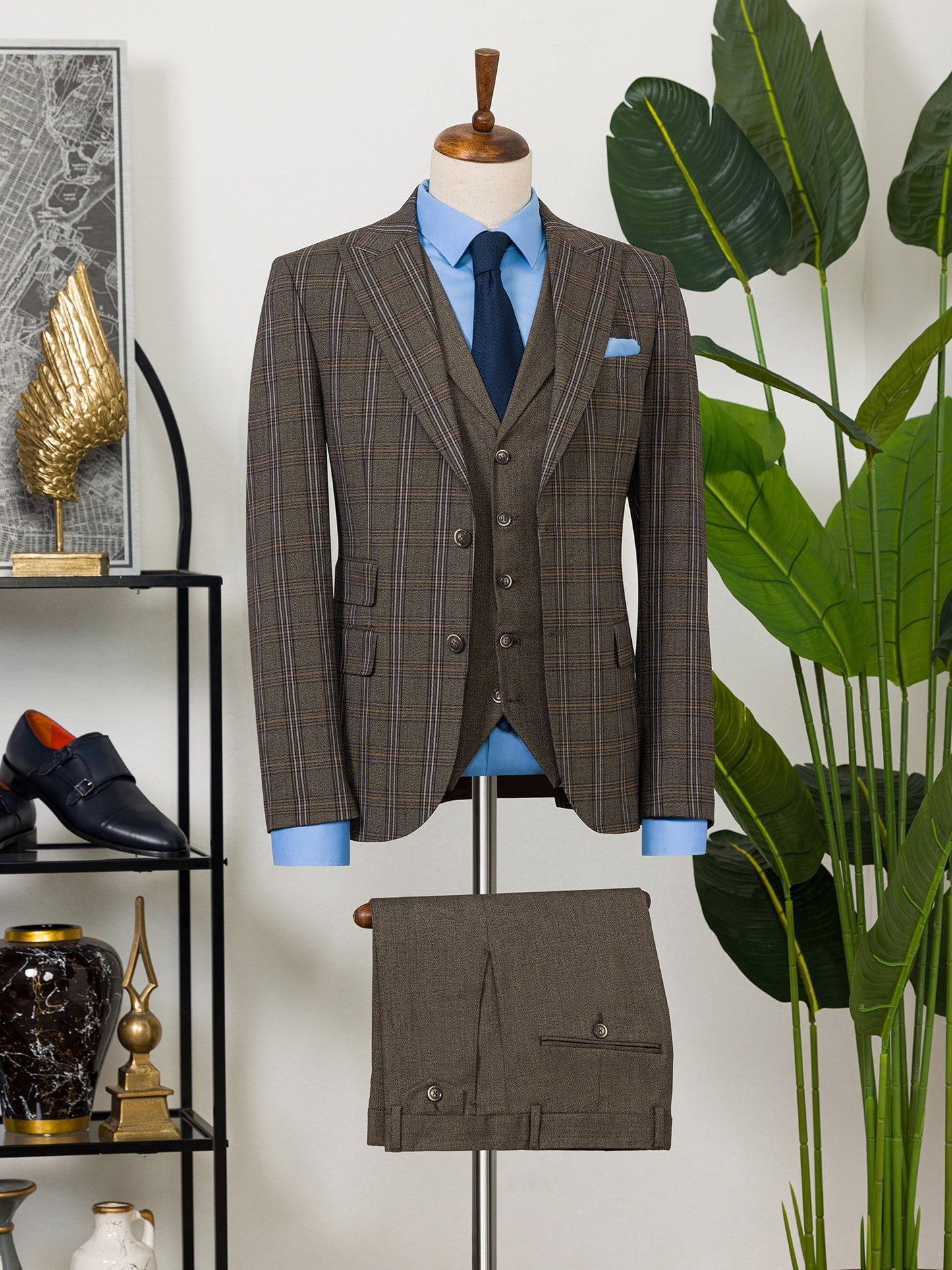 Men’s brown plaid slim-fit 3-piece suit with peak lapel blazer, matching vest and trousers, styled for formal and smart occasions with a modern tailored silhouette.