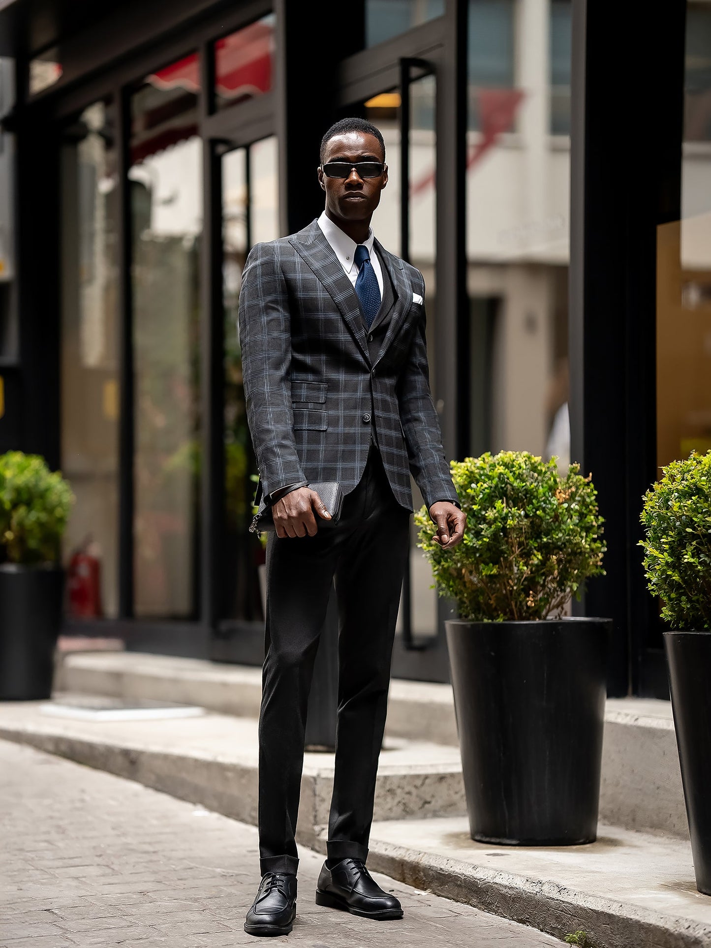 Men’s navy plaid slim-fit 3-piece suit with peak lapel blazer, matching vest and trousers, styled for business and formal occasions with a modern tailored fit.