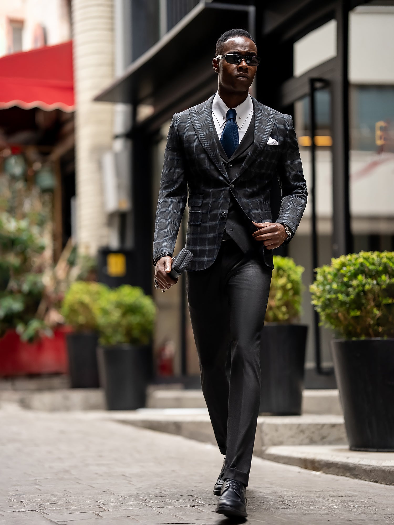 Men’s navy plaid slim-fit 3-piece suit with peak lapel blazer, matching vest and trousers, styled for business and formal occasions with a modern tailored fit.