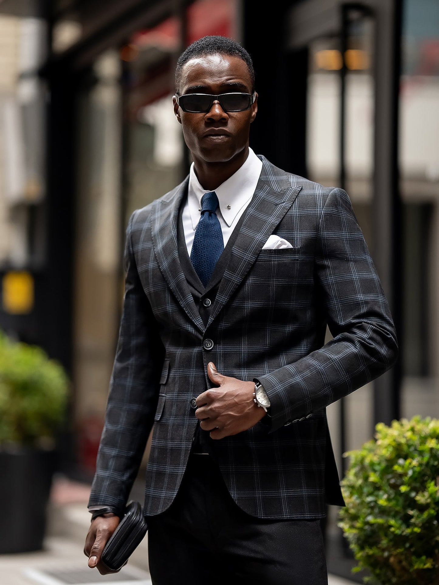 Men’s navy plaid slim-fit 3-piece suit with peak lapel blazer, matching vest and trousers, styled for business and formal occasions with a modern tailored fit.