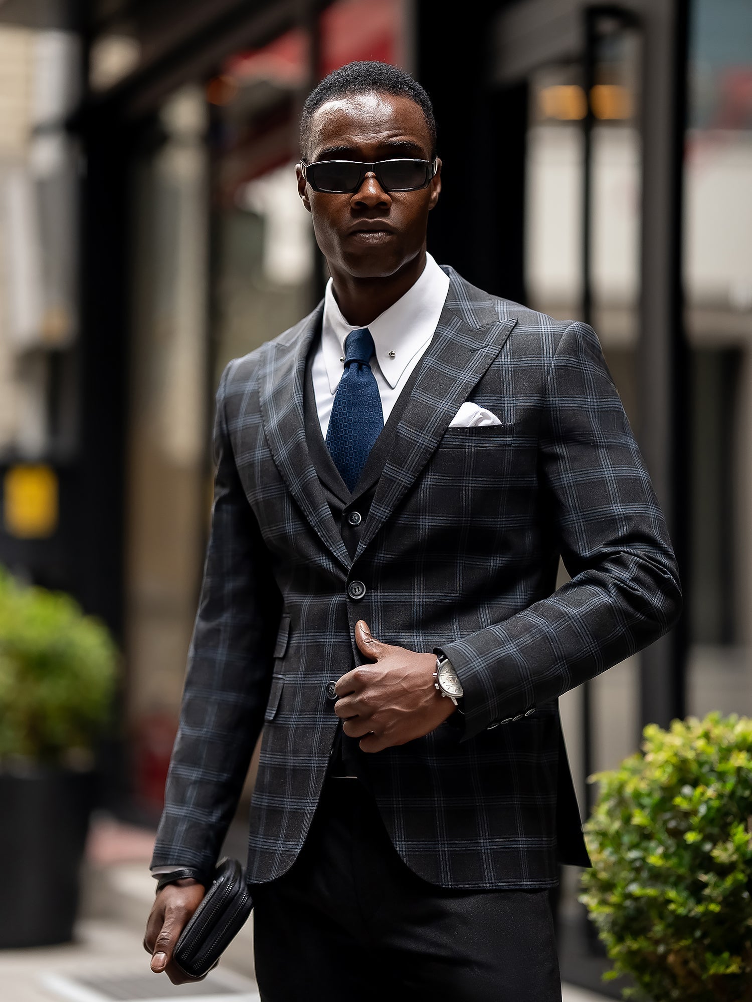 Men’s navy plaid slim-fit 3-piece suit with peak lapel blazer, matching vest and trousers, styled for business and formal occasions with a modern tailored fit.
