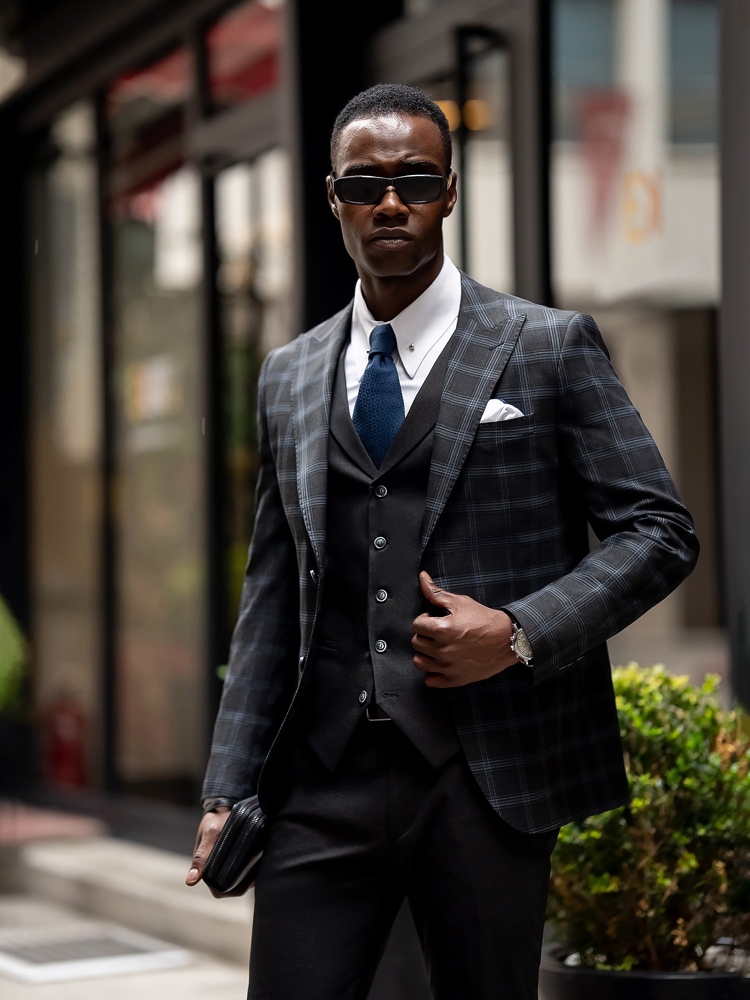 Men’s navy plaid slim-fit 3-piece suit with peak lapel blazer, matching vest and trousers, styled for business and formal occasions with a modern tailored fit.