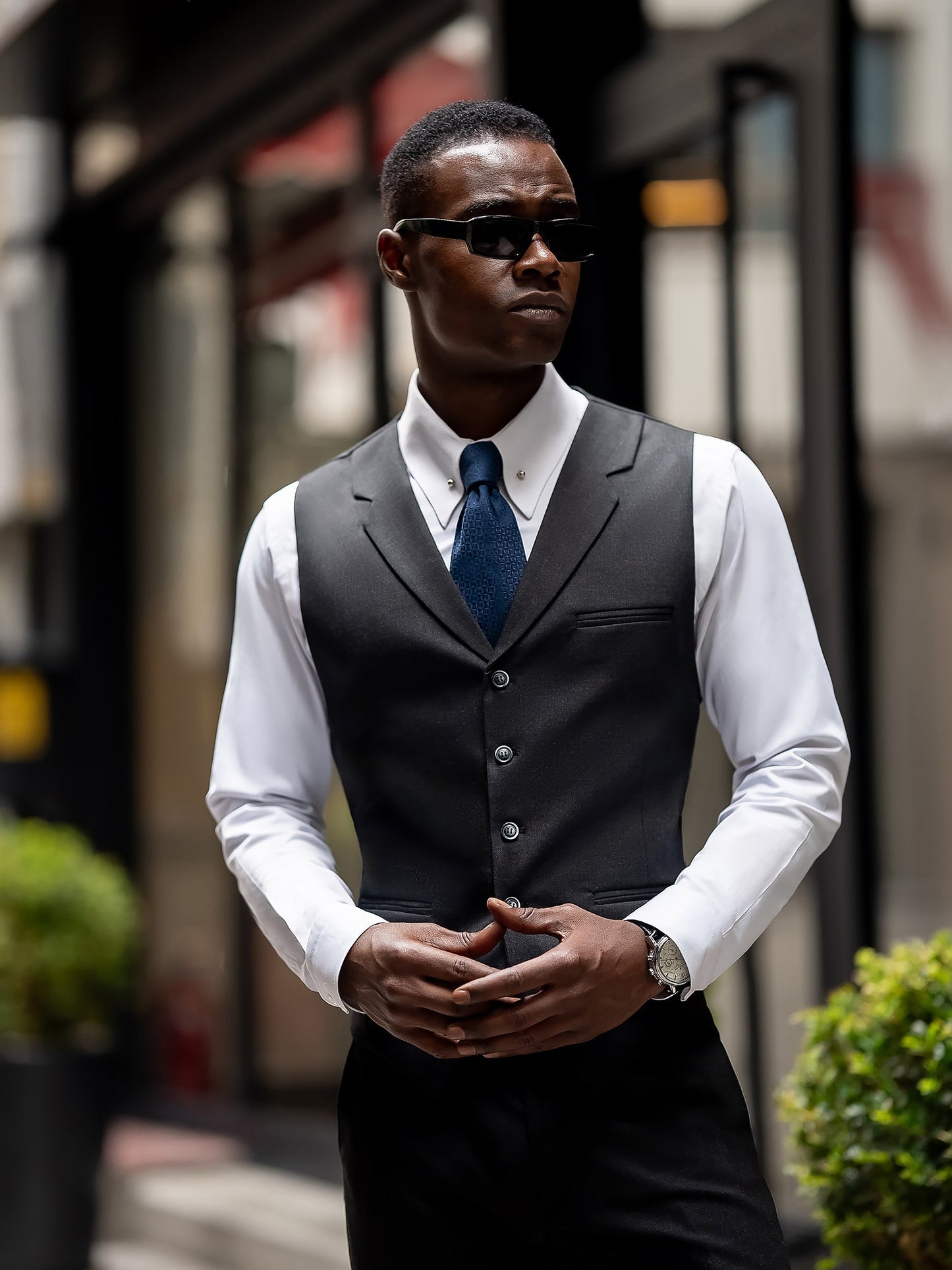 Men’s navy plaid slim-fit 3-piece suit with peak lapel blazer, matching vest and trousers, styled for business and formal occasions with a modern tailored fit.