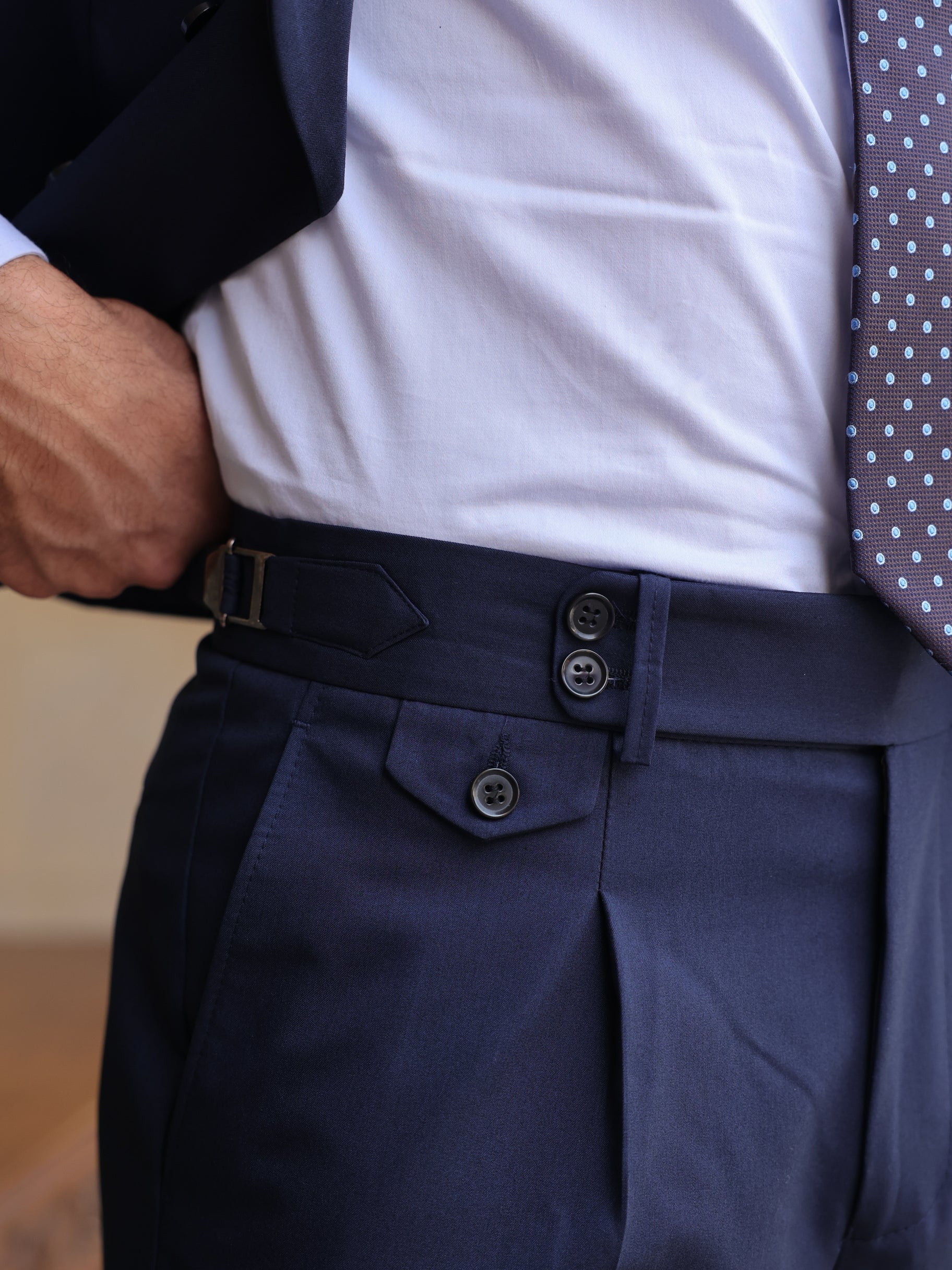 Men’s navy modern-fit 3-piece suit with blazer, waistcoat, and trousers, styled with a white shirt and patterned tie for a clean, elegant look.