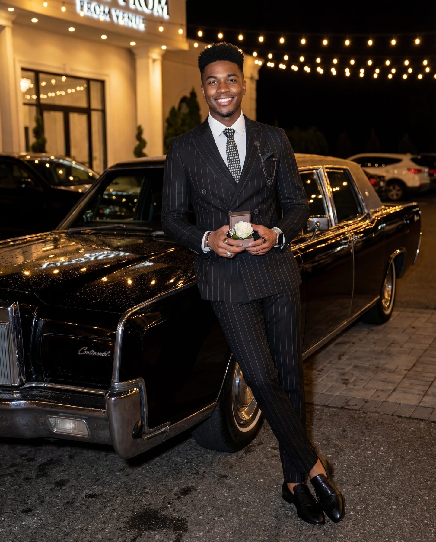 Black double-breasted pinstripe prom suit worn by young male model at formal event