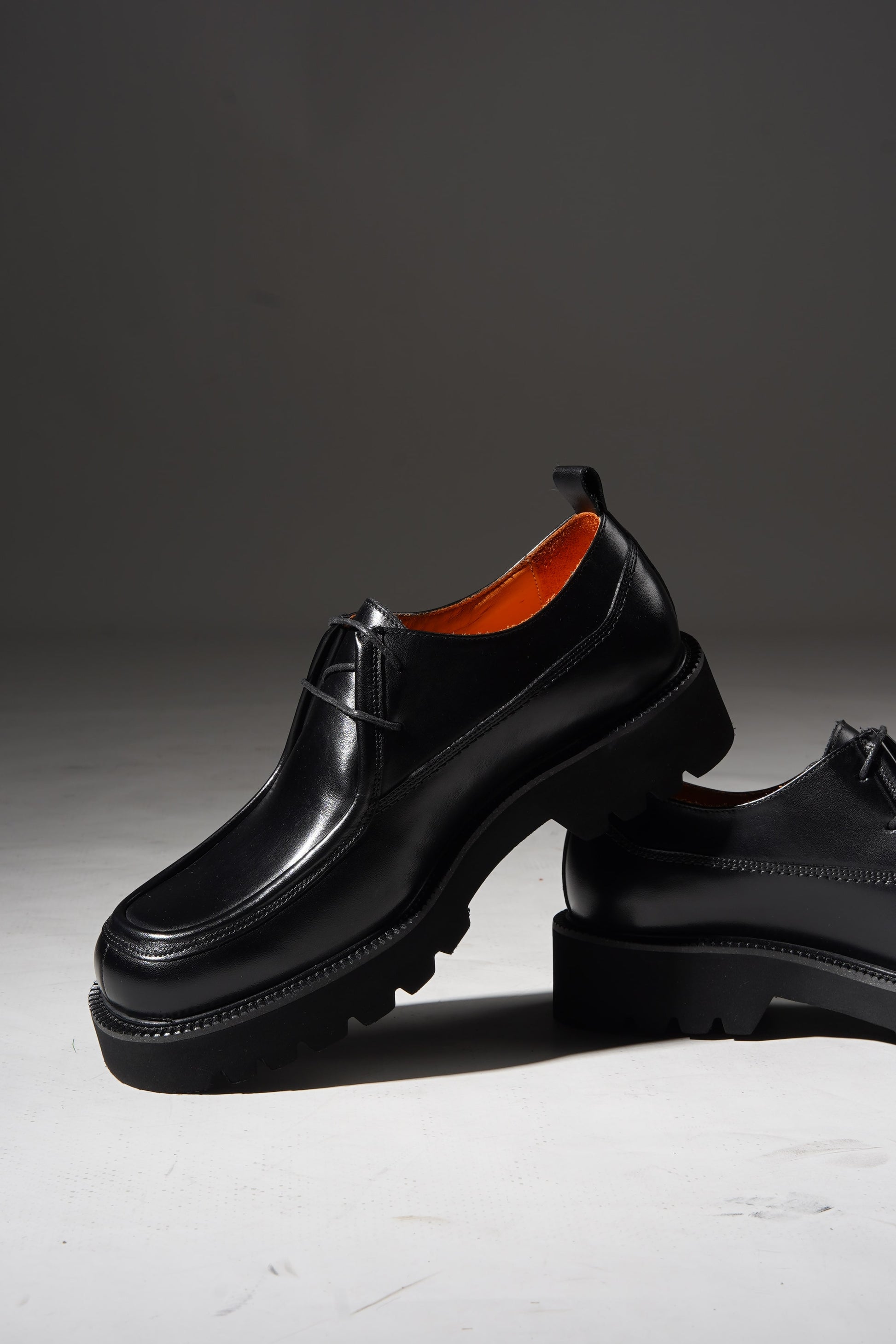 Pair of Black Apron-Toe Chunky Derby Shoes with chunky sole displayed stylishly