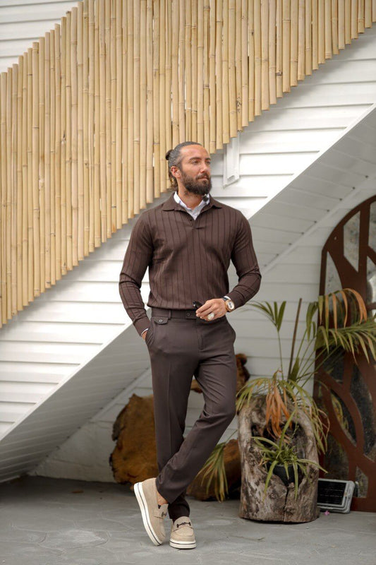 A man wearing a brown ribbed long sleeve polo knitwear with a slim fit, styled with matching brown trousers and beige loafers.