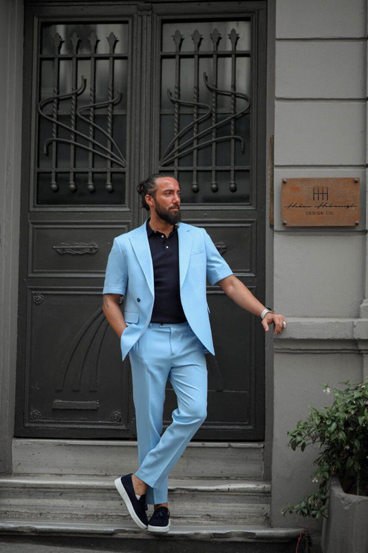 Side view of the HolloMen Bandol ice blue short-sleeve suit styled with sneakers