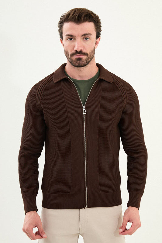 A man wearing a slim fit brown ribbed zip cardigan with a polo collar, styled with beige trousers.