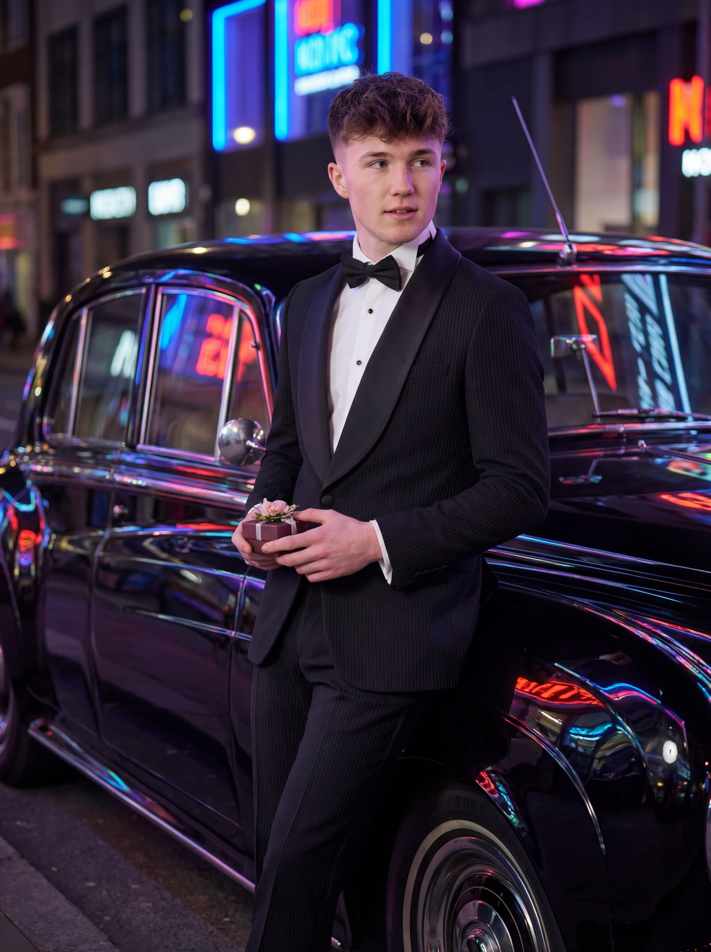 Black prom tuxedo styled with bow tie and tailored trousers for prom night