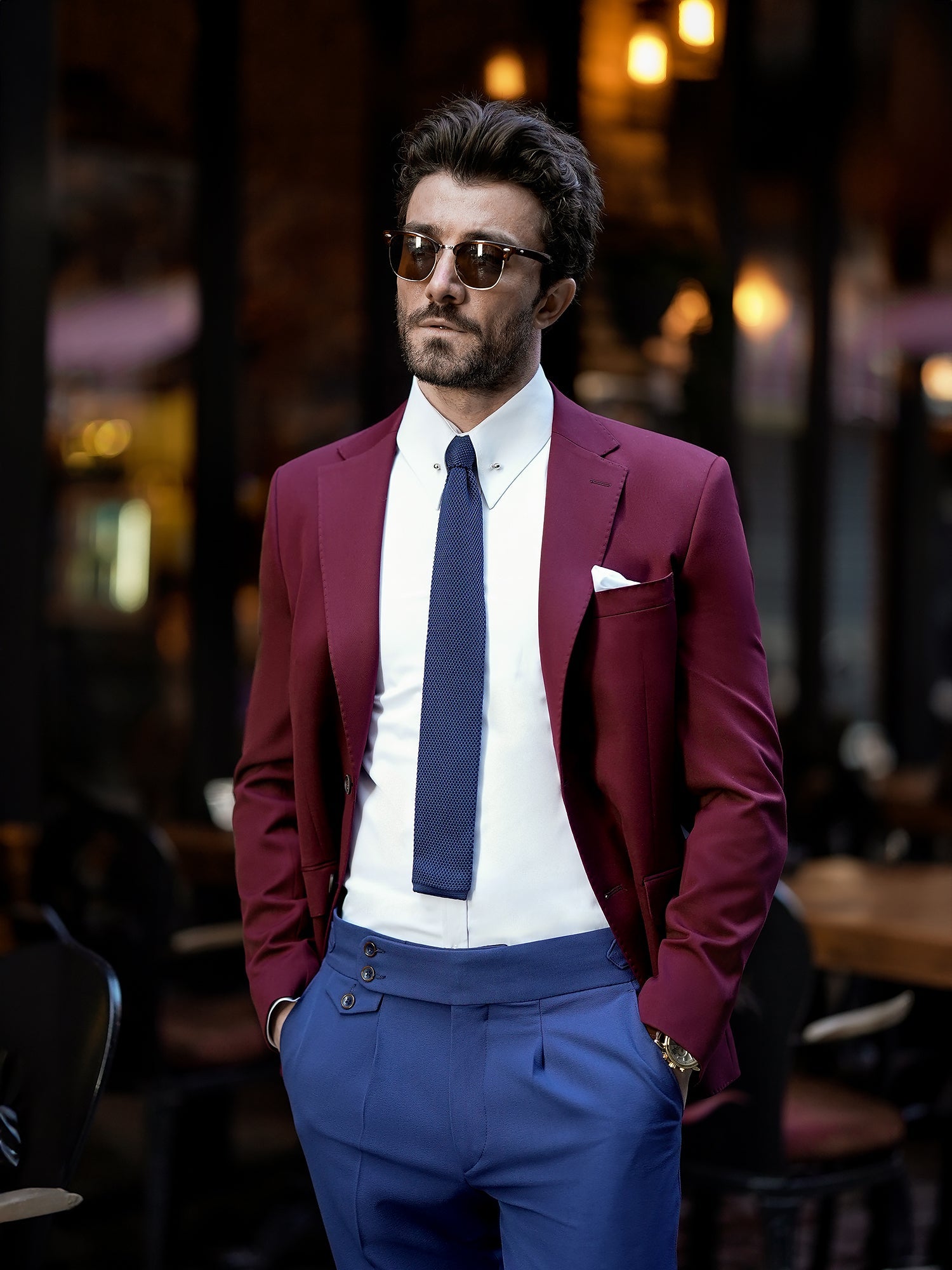 Men’s bordeaux slim-fit blazer with peak lapels, single-breasted design, double vents, and tailored silhouette, styled for formal and smart-casual occasions.