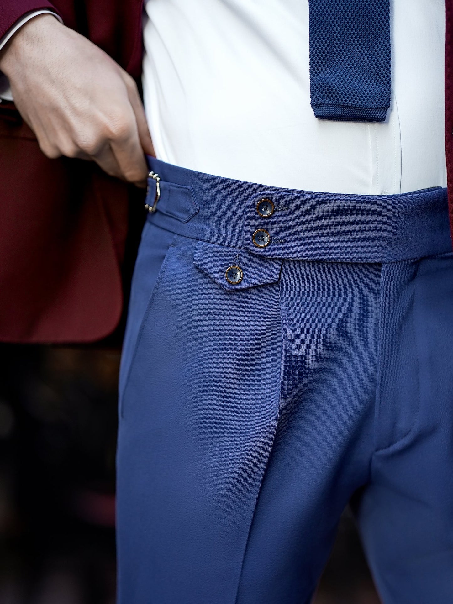 Men’s bordeaux slim-fit blazer with peak lapels, single-breasted design, double vents, and tailored silhouette, styled for formal and smart-casual occasions.