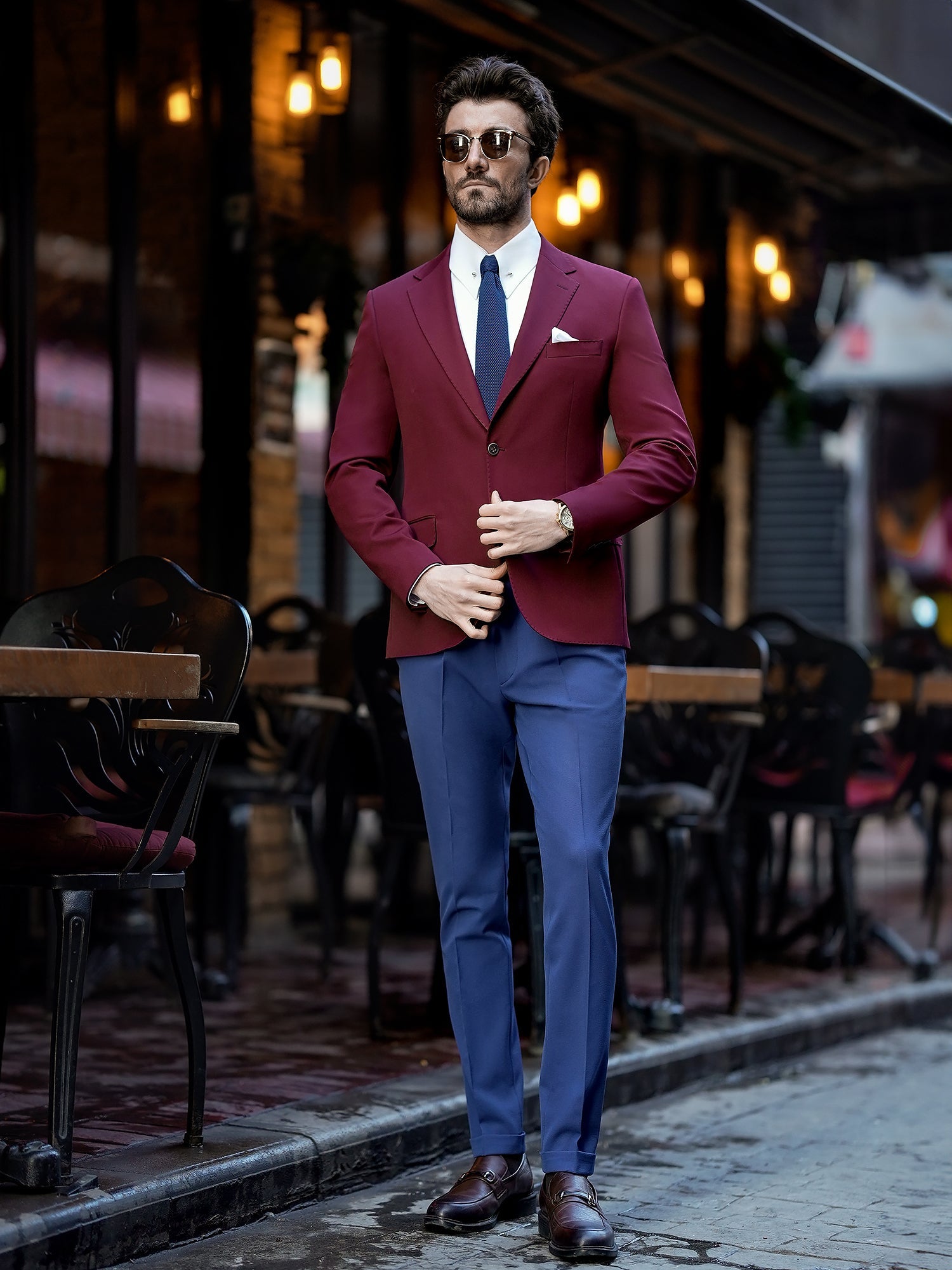 Men’s bordeaux slim-fit blazer with peak lapels, single-breasted design, double vents, and tailored silhouette, styled for formal and smart-casual occasions.