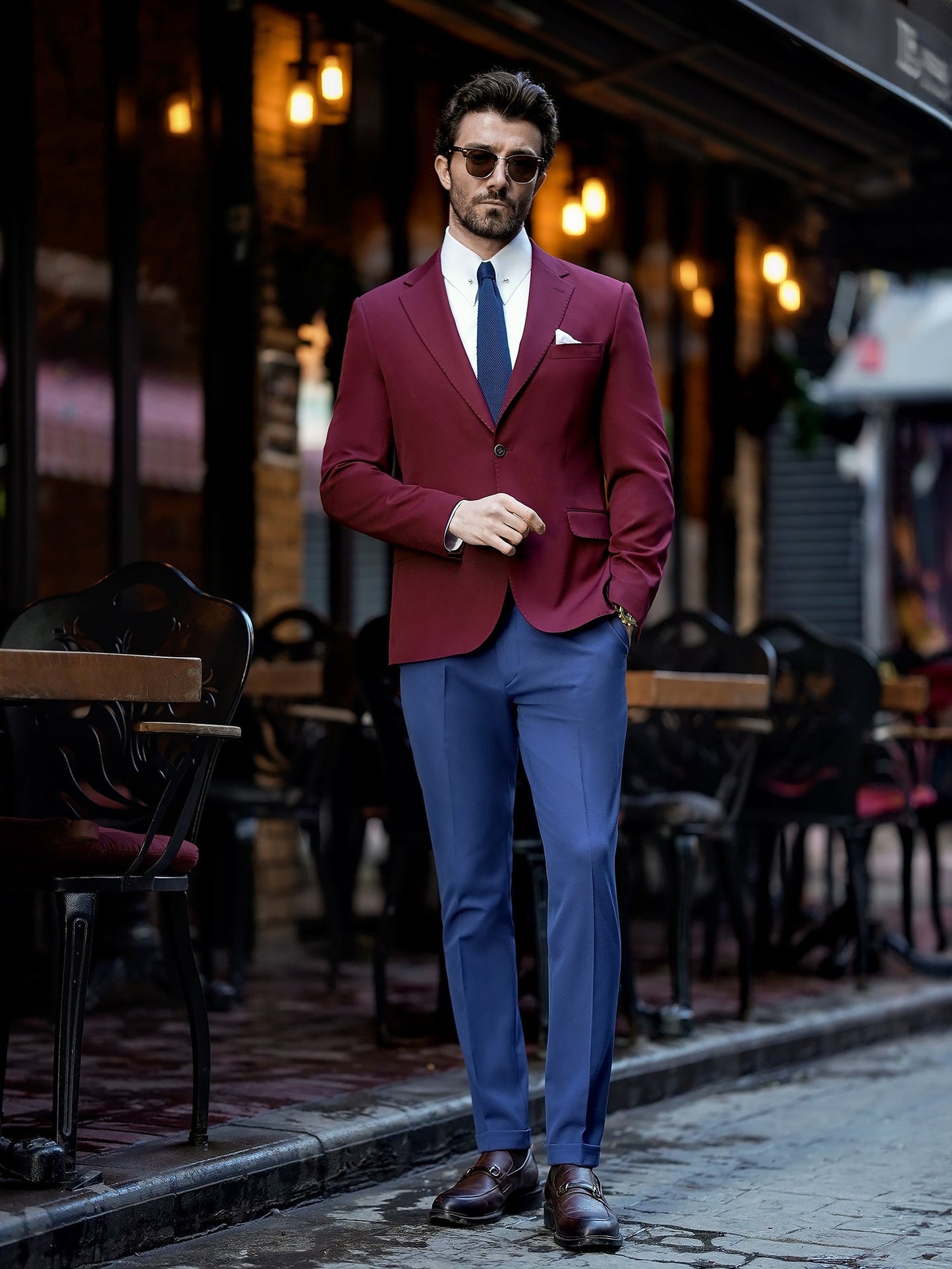 Men’s bordeaux slim-fit blazer with peak lapels, single-breasted design, double vents, and tailored silhouette, styled for formal and smart-casual occasions.
