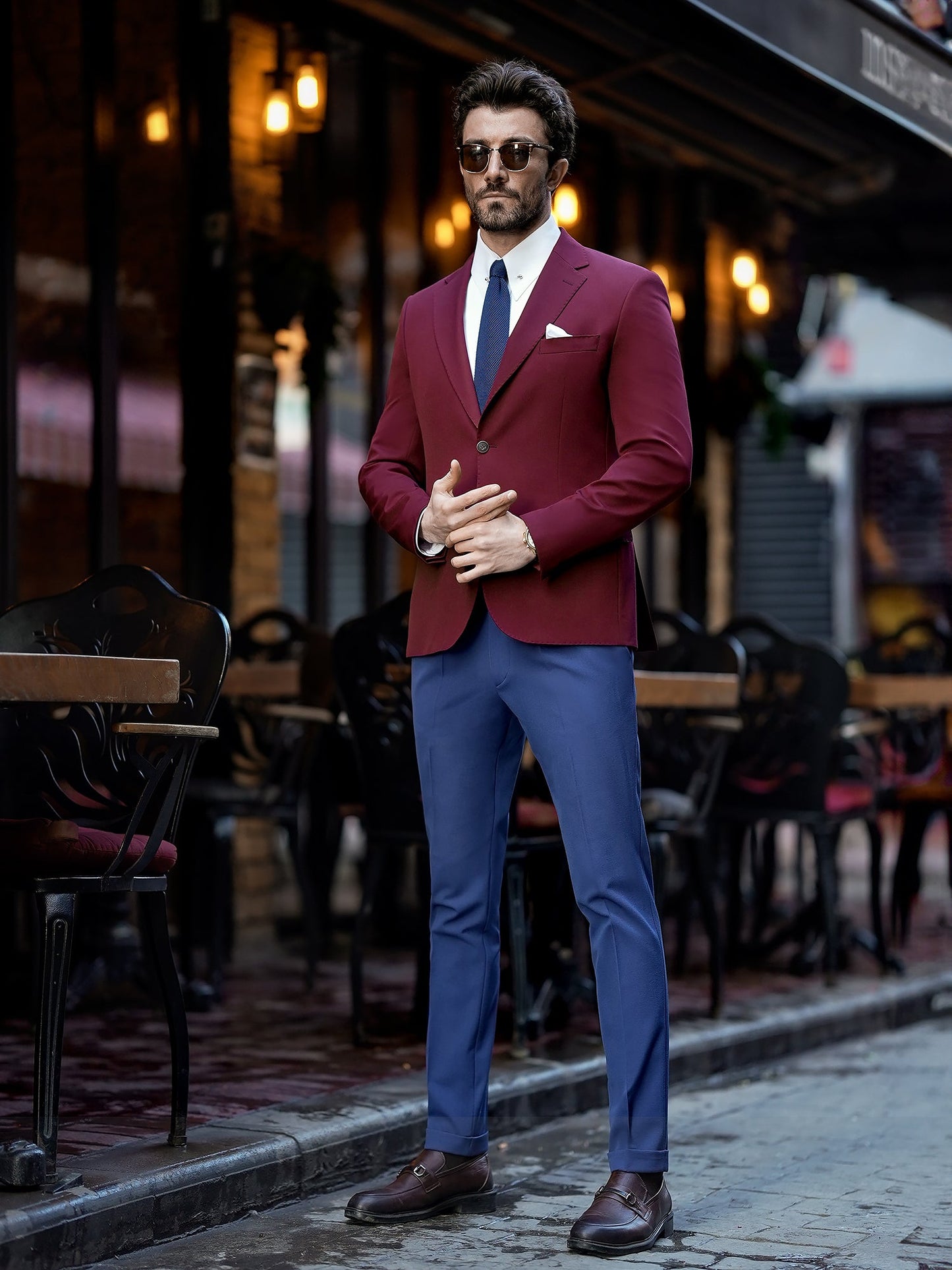 Men’s bordeaux slim-fit blazer with peak lapels, single-breasted design, double vents, and tailored silhouette, styled for formal and smart-casual occasions.