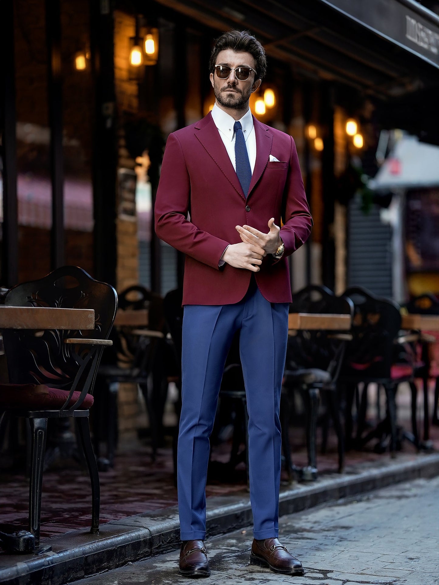 Men’s bordeaux slim-fit blazer with peak lapels, single-breasted design, double vents, and tailored silhouette, styled for formal and smart-casual occasions.