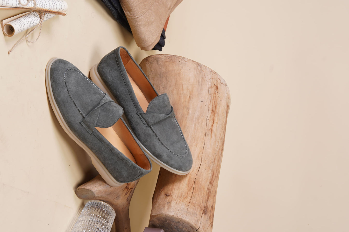 Men’s grey suede leather penny loafers featuring classic vamp strap detail and lightweight cream sole.