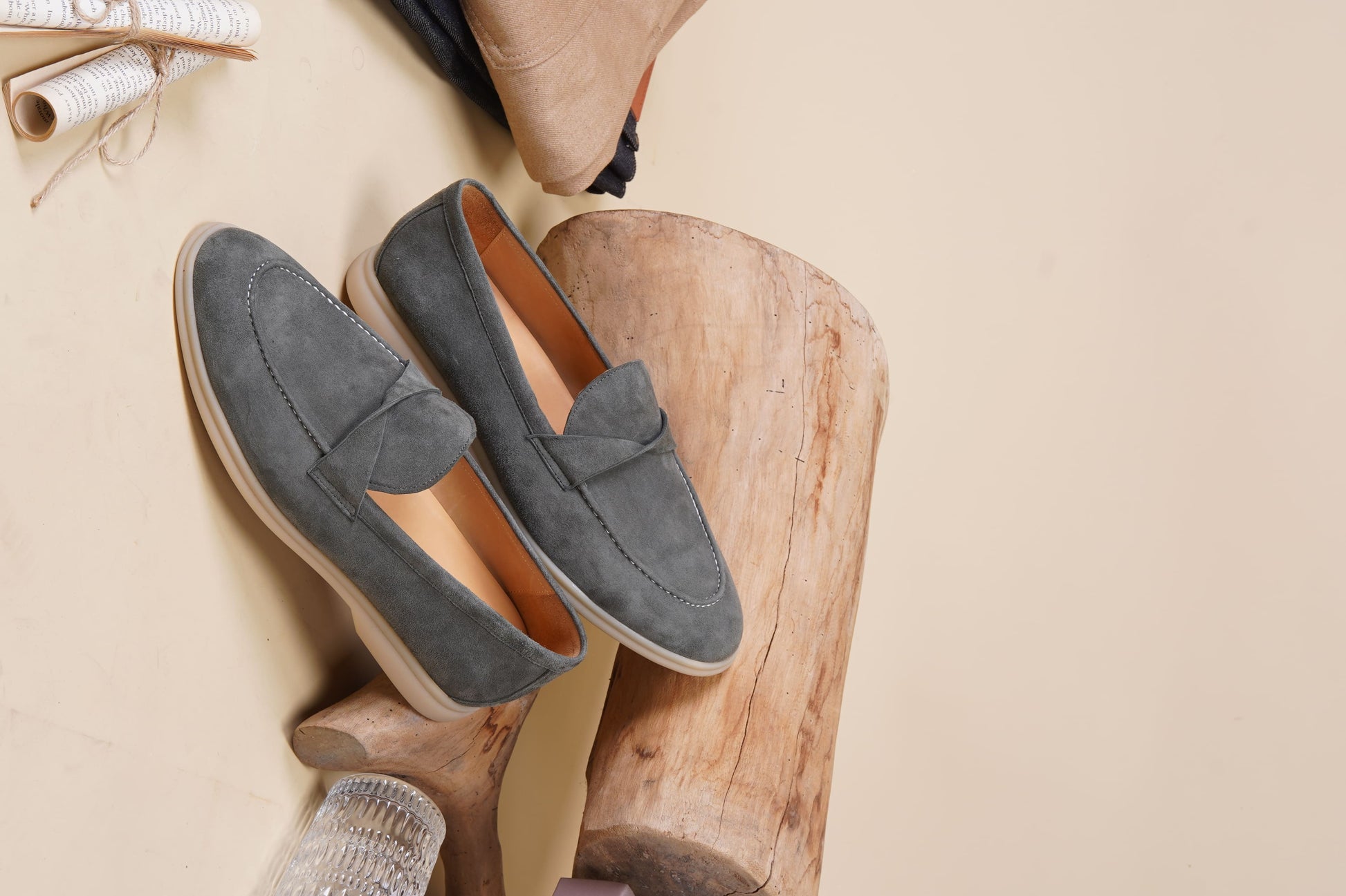 Men’s grey suede leather penny loafers featuring classic vamp strap detail and lightweight cream sole.