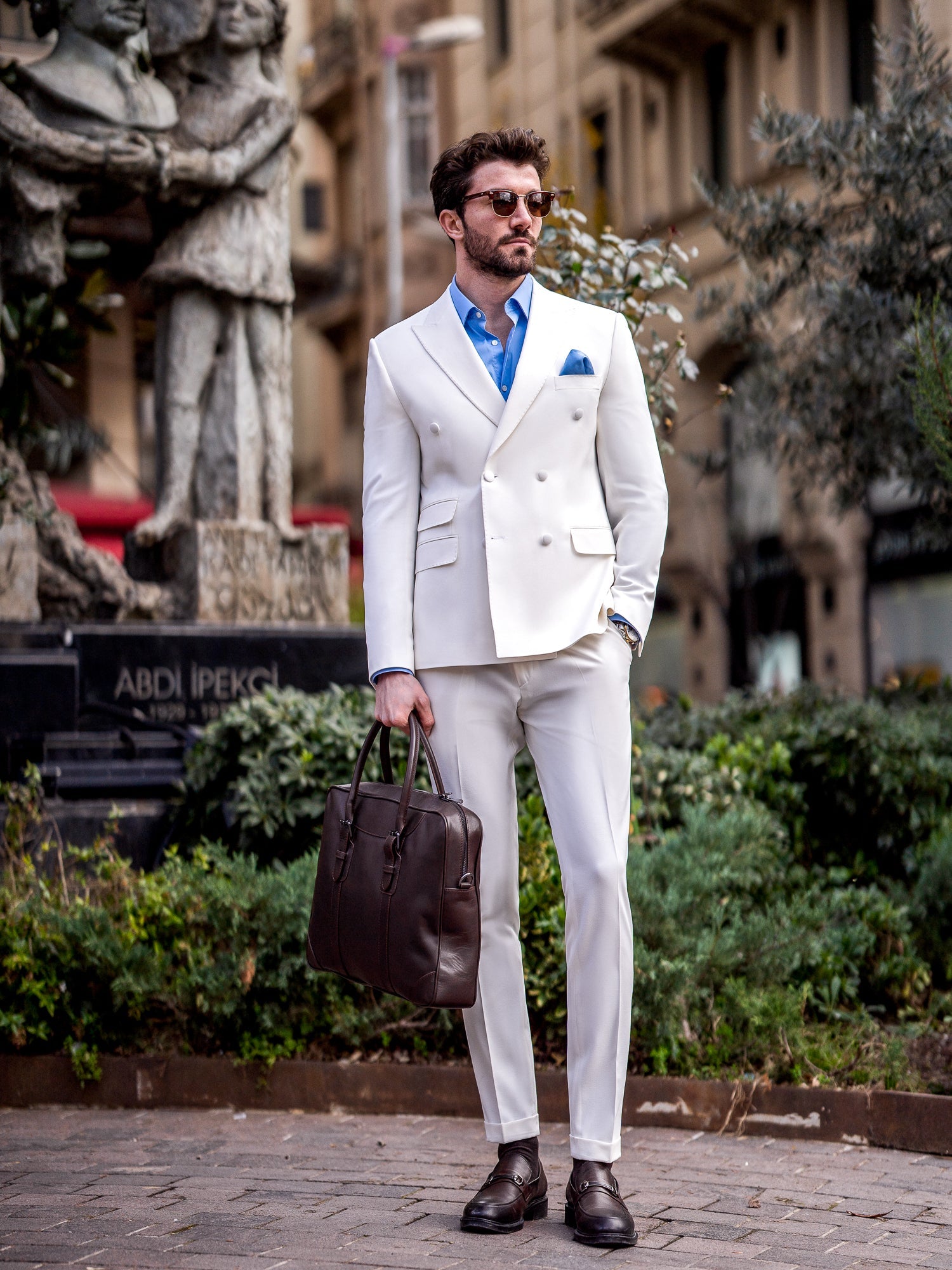 Men’s white slim-fit double-breasted suit with peak lapel blazer and tailored trousers, featuring a six-button design, double vents, and a modern structured silhouette for formal occasions.