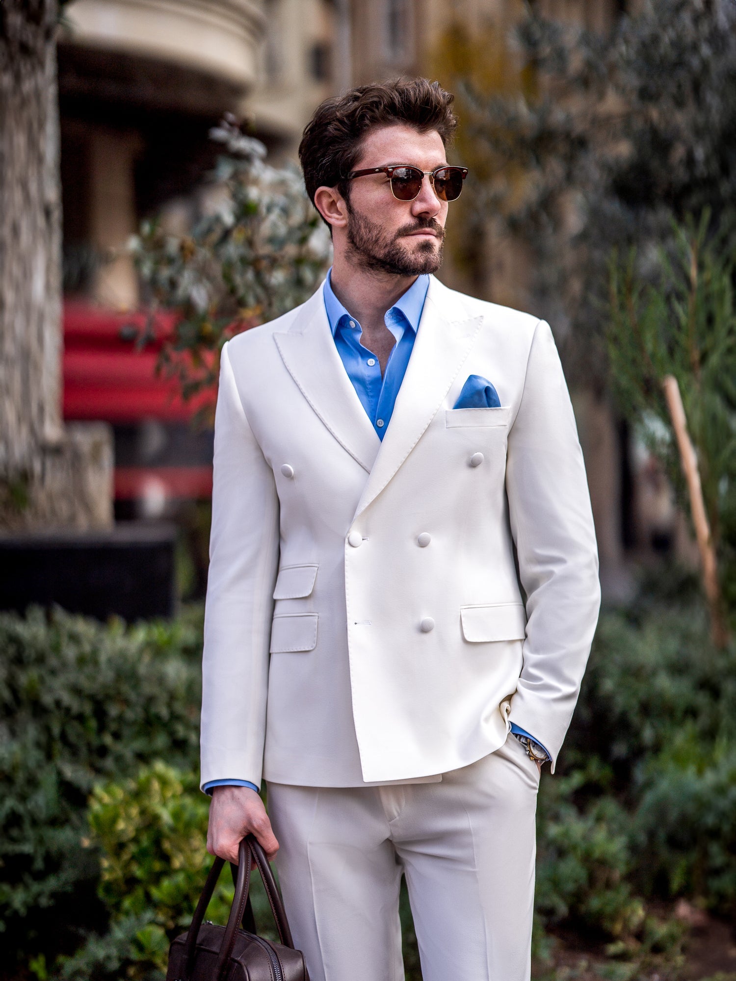 Men’s white slim-fit double-breasted suit with peak lapel blazer and tailored trousers, featuring a six-button design, double vents, and a modern structured silhouette for formal occasions.