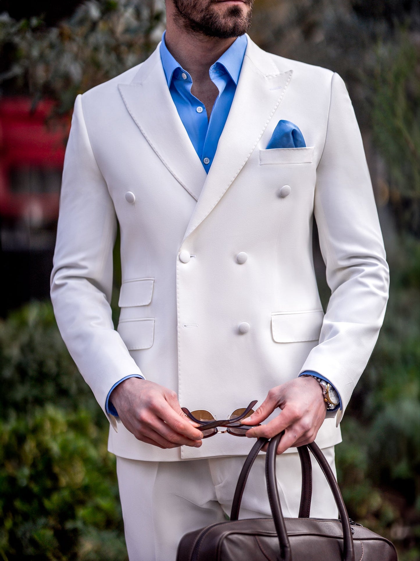 Men’s white slim-fit double-breasted suit with peak lapel blazer and tailored trousers, featuring a six-button design, double vents, and a modern structured silhouette for formal occasions.