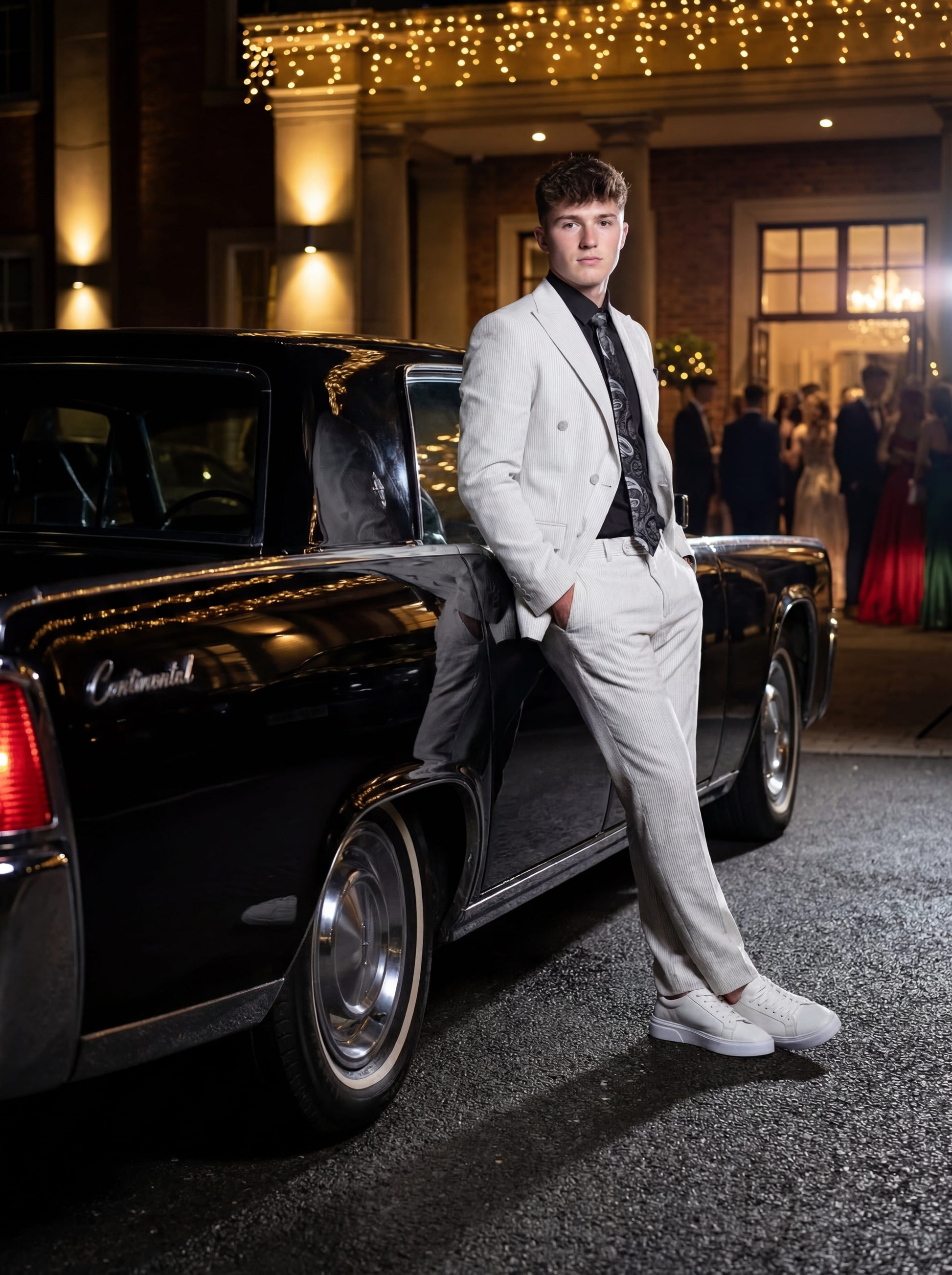 Gray double-breasted pinstripe prom suit worn by young male model at formal event