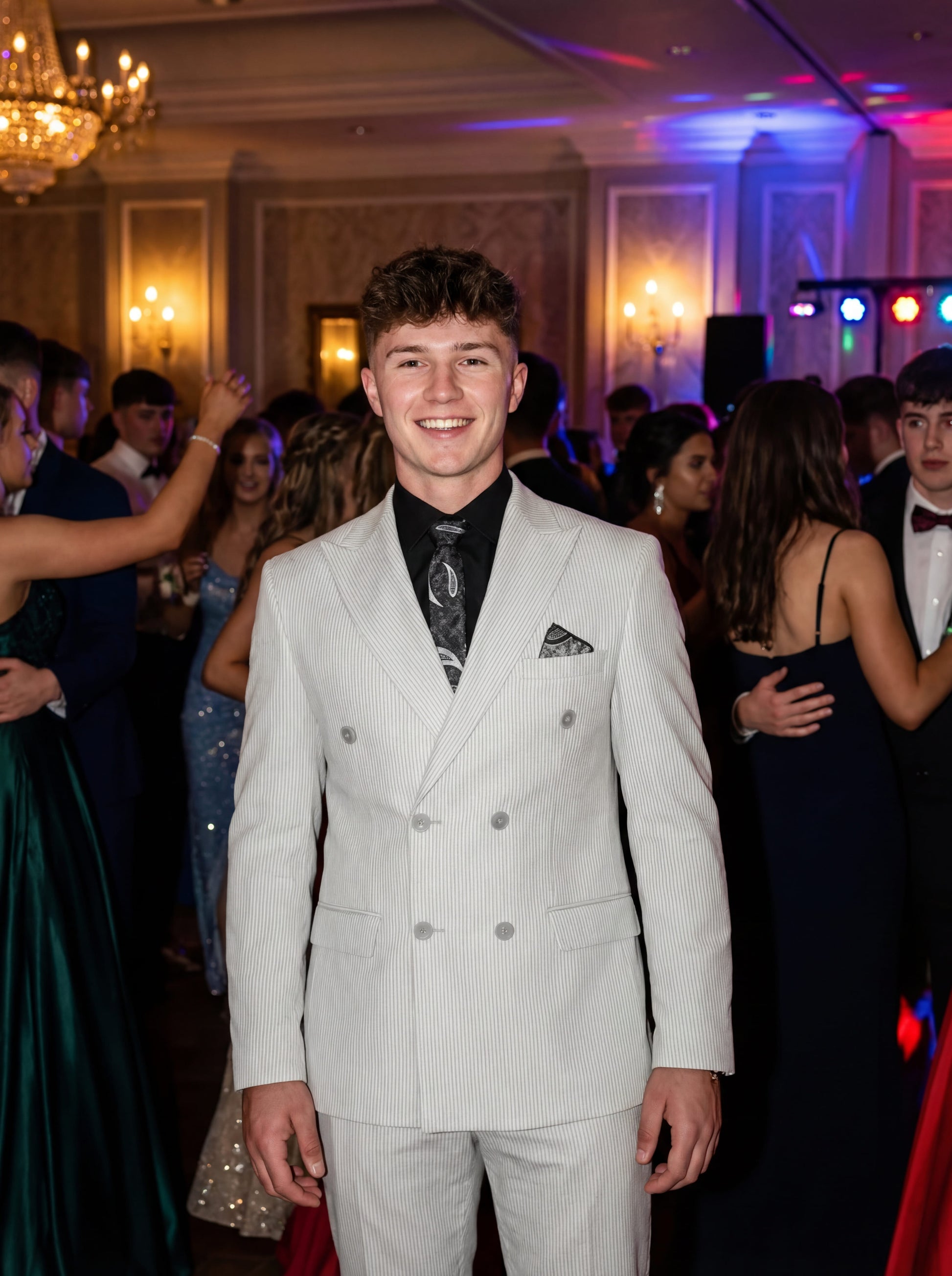 Gray double-breasted pinstripe prom suit worn by young male model at formal event
