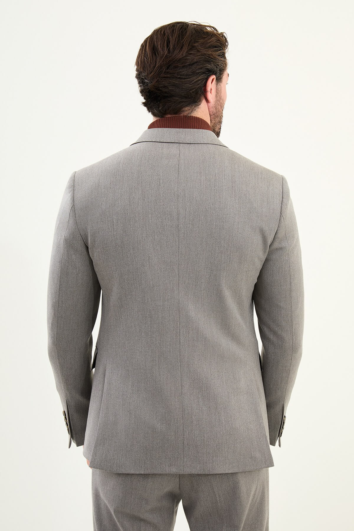 Men’s heather gray slim-fit double-breasted wool-blend suit with wide peak lapels, barchetta chest pocket, tortoiseshell buttons, and red origami lapel pin.