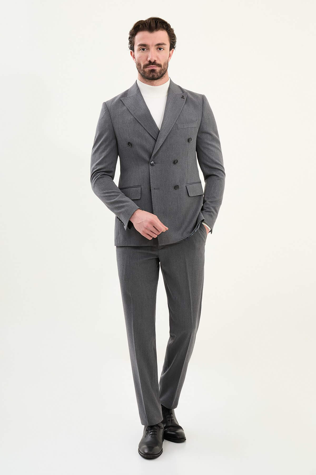 Men’s heather gray slim-fit double-breasted wool-blend suit with wide peak lapels, point-stitch lapel edges, barchetta chest pocket, mottled buttons, and origami lapel pin.