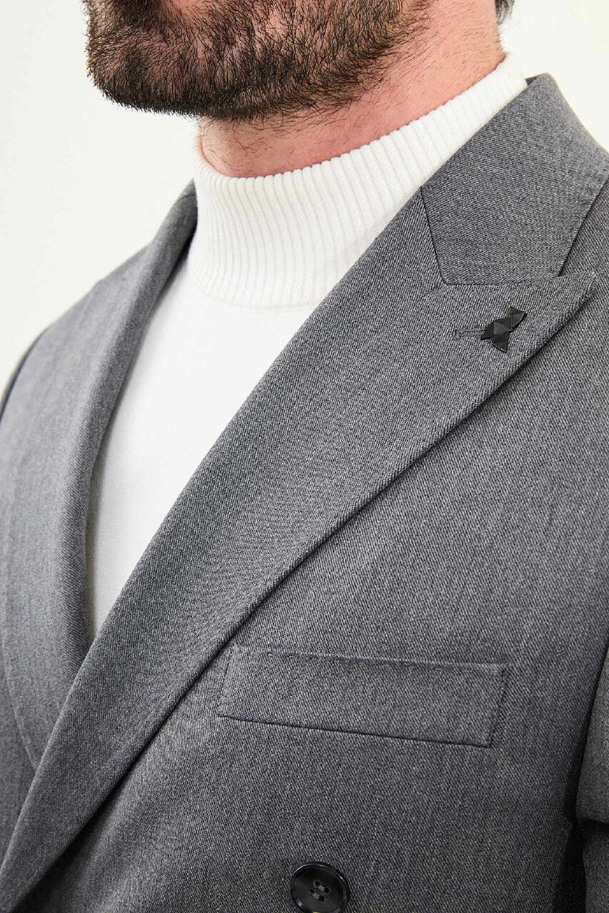 Men’s heather gray slim-fit double-breasted wool-blend suit with wide peak lapels, point-stitch lapel edges, barchetta chest pocket, mottled buttons, and origami lapel pin.