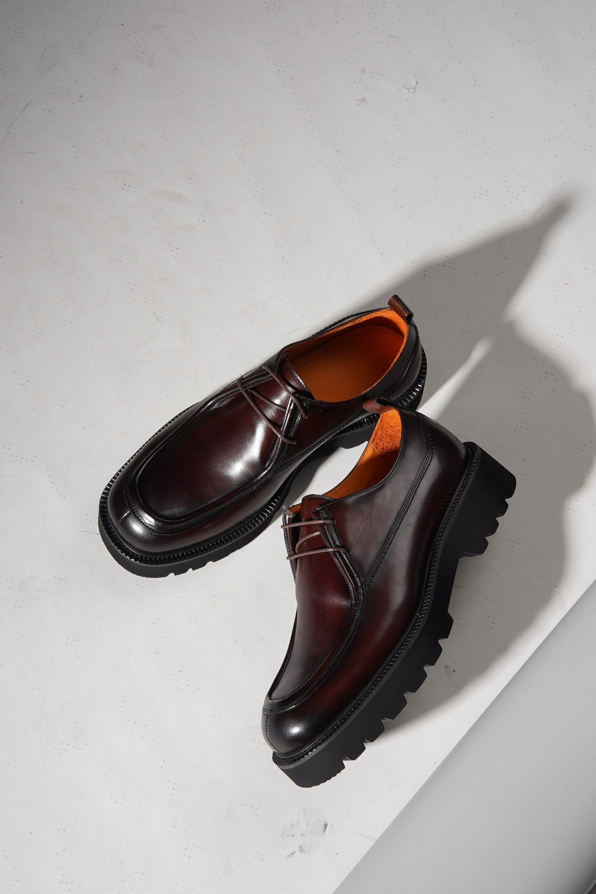 Angled pair view of Bordeaux Split-Toe Derby Shoes highlighting craftsmanship and Bordeaux hue.