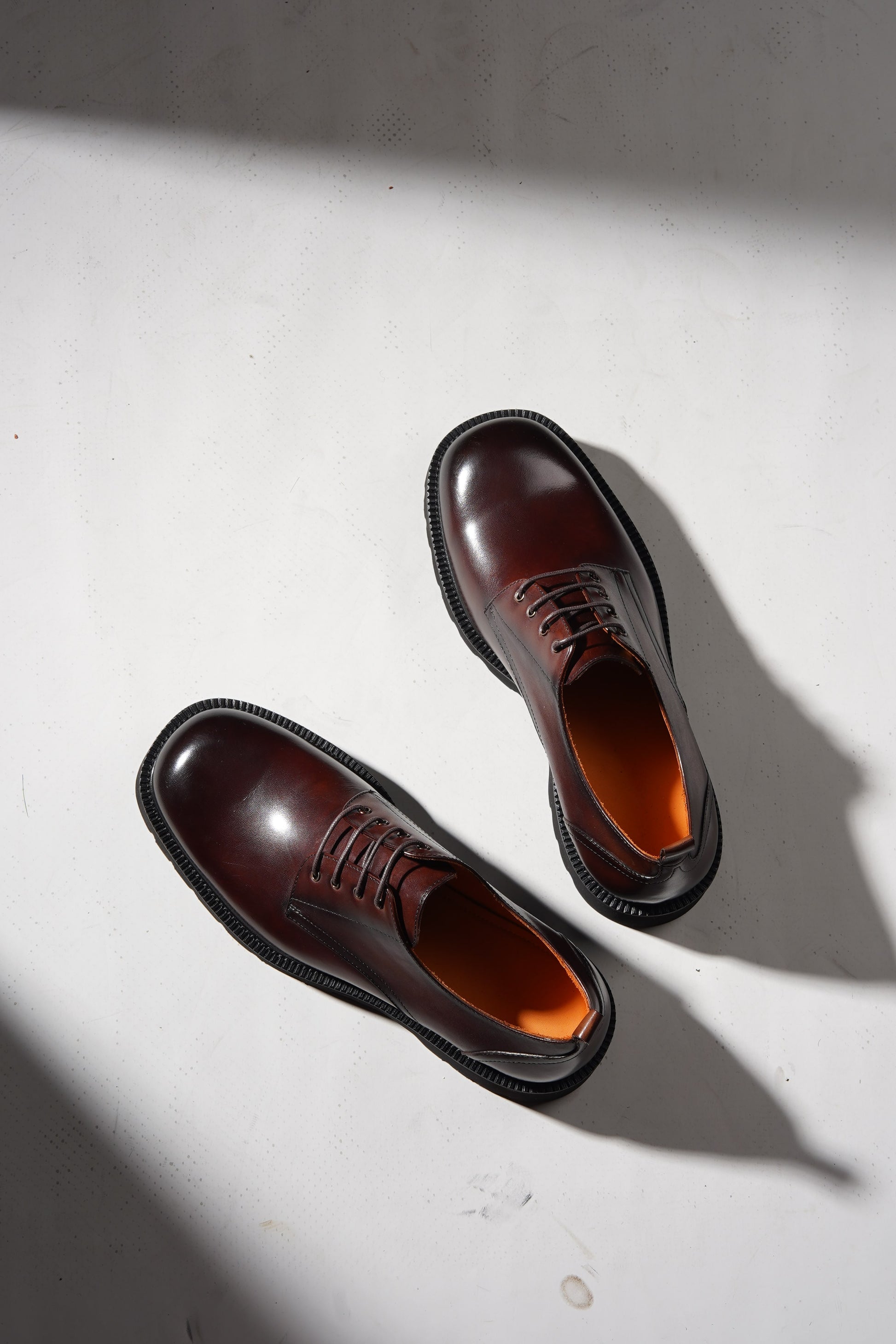 pair of brown derby shoes showcasing premium leather upper and chunky EVA outsole.