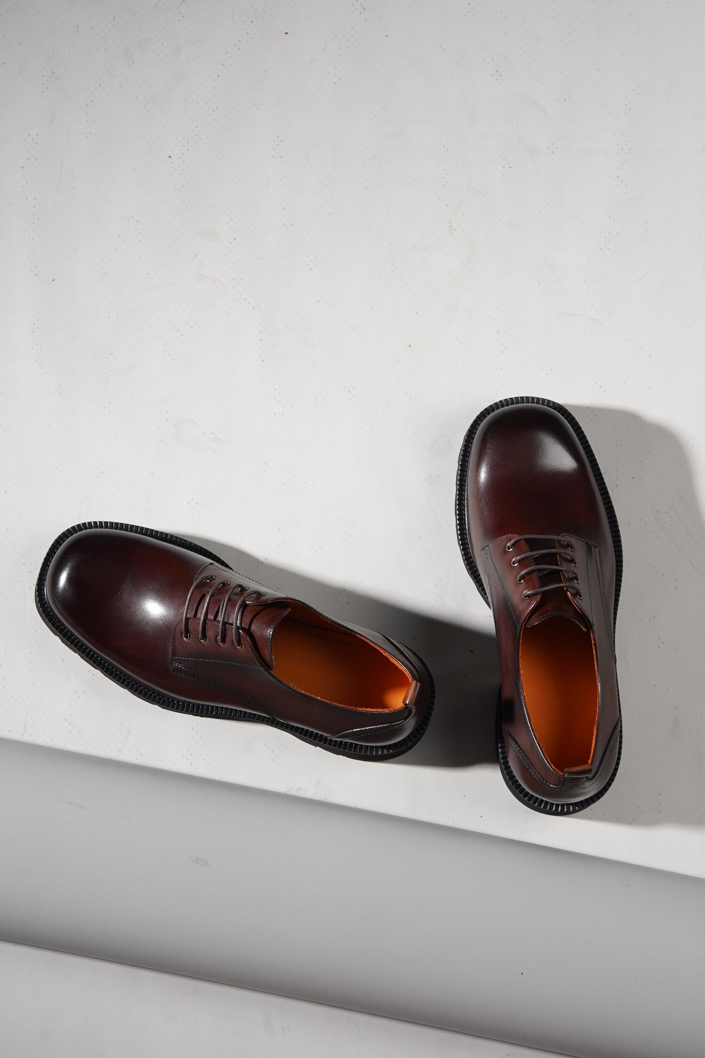 pair of brown derby shoes showcasing premium leather upper and chunky EVA outsole.