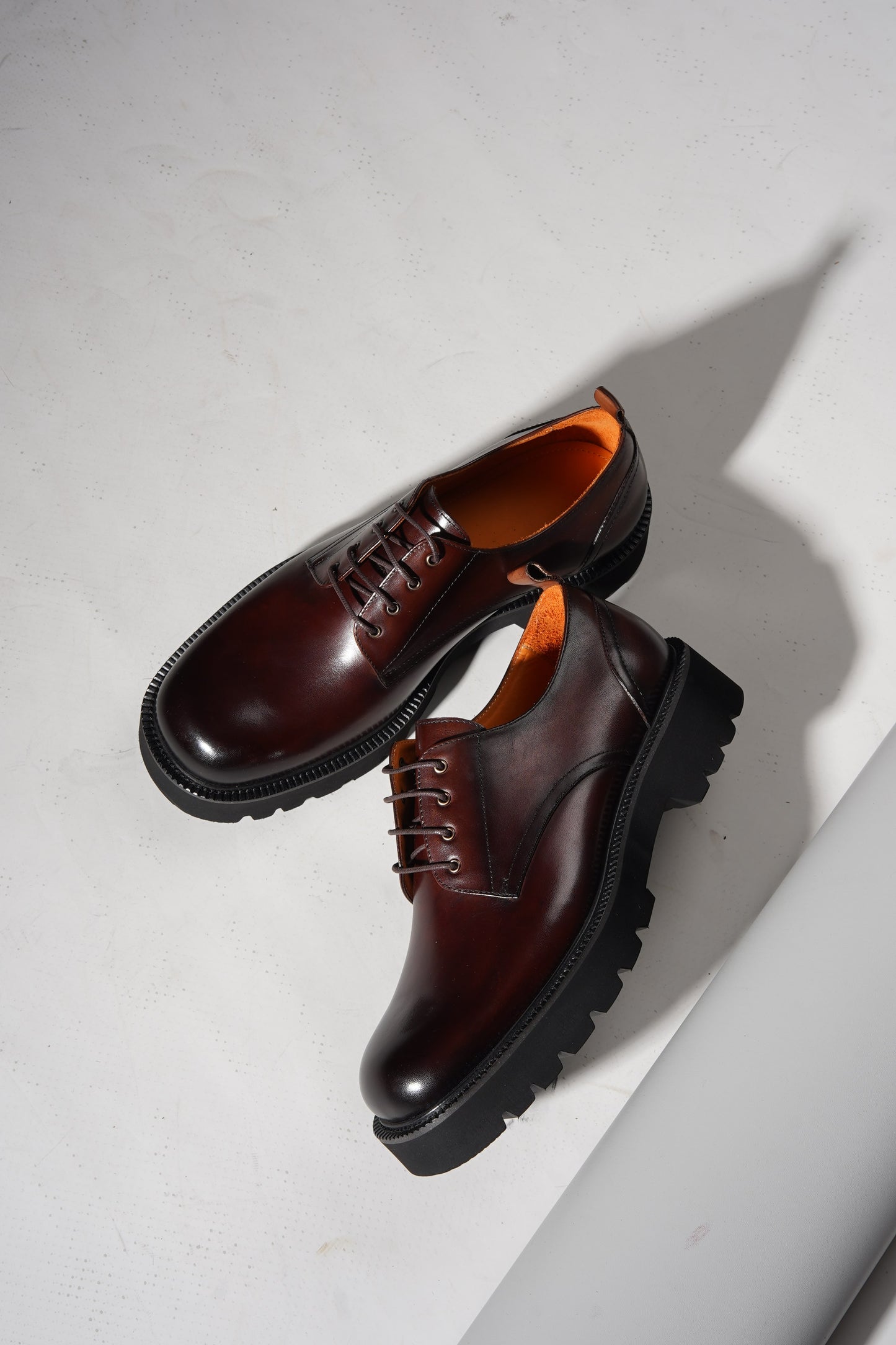 pair of brown derby shoes showcasing premium leather upper and chunky EVA outsole.