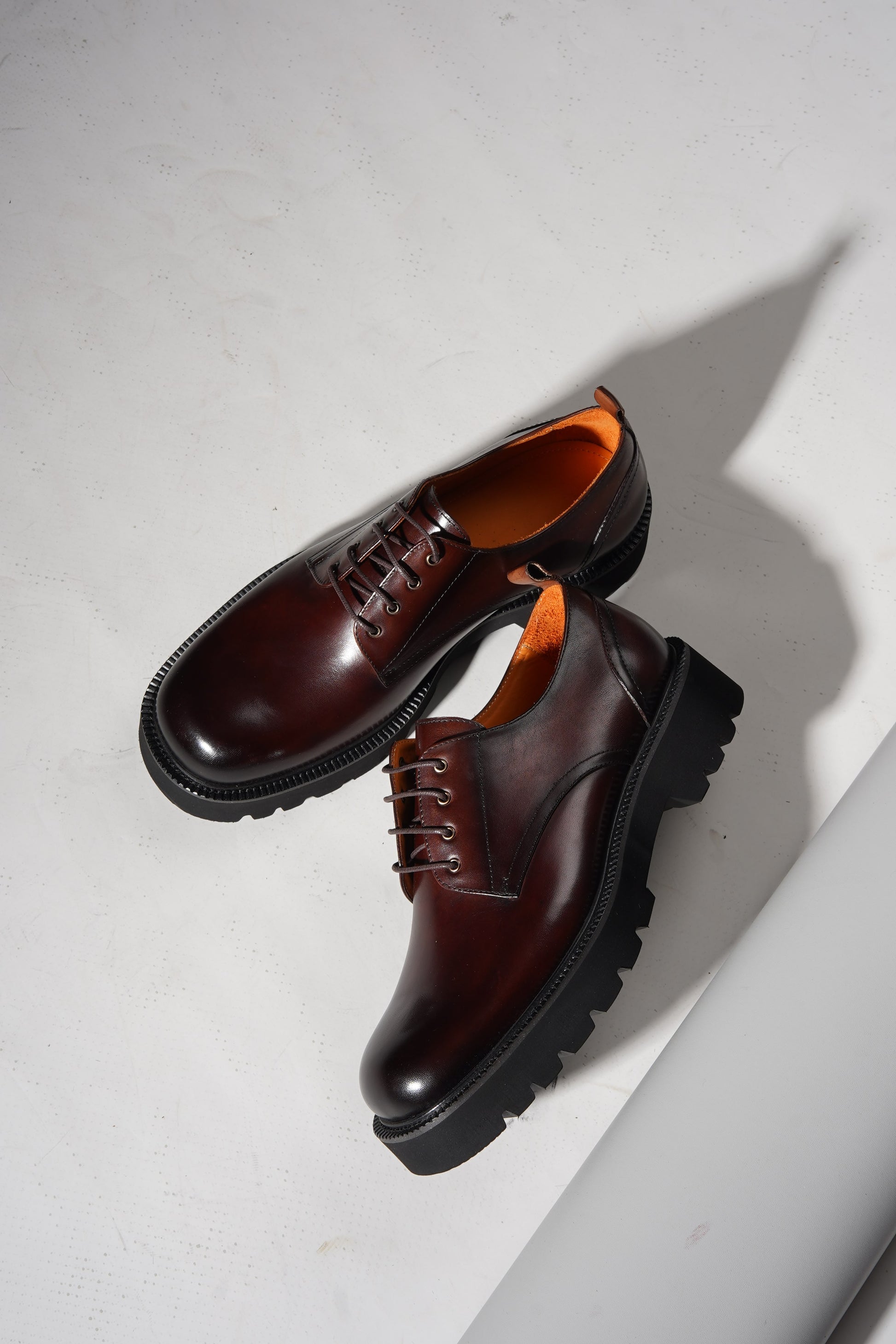 pair of brown derby shoes showcasing premium leather upper and chunky EVA outsole.
