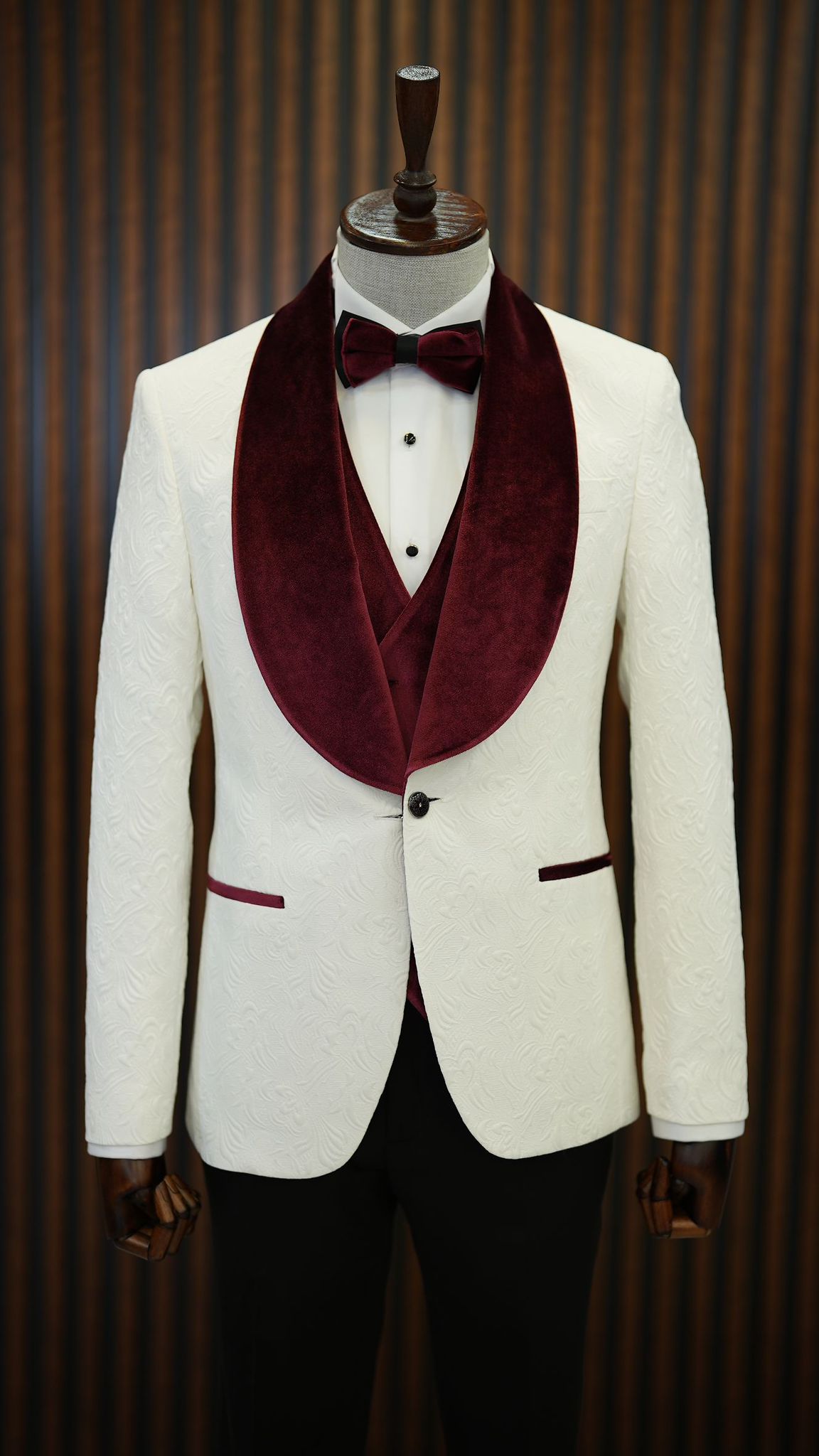A Burgundy and White Tuxedo Suit on display.