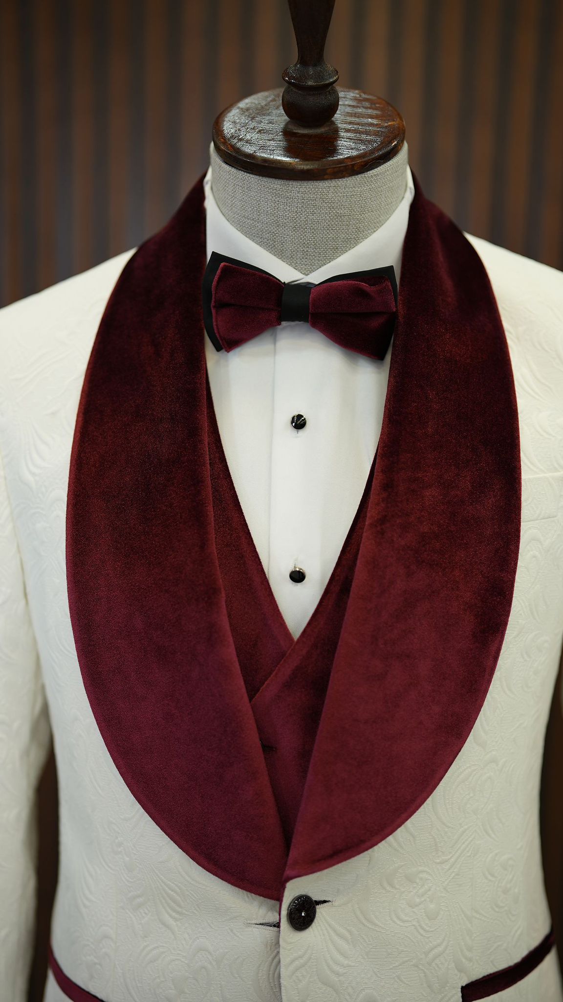 A Burgundy and White Tuxedo Suit on display.
