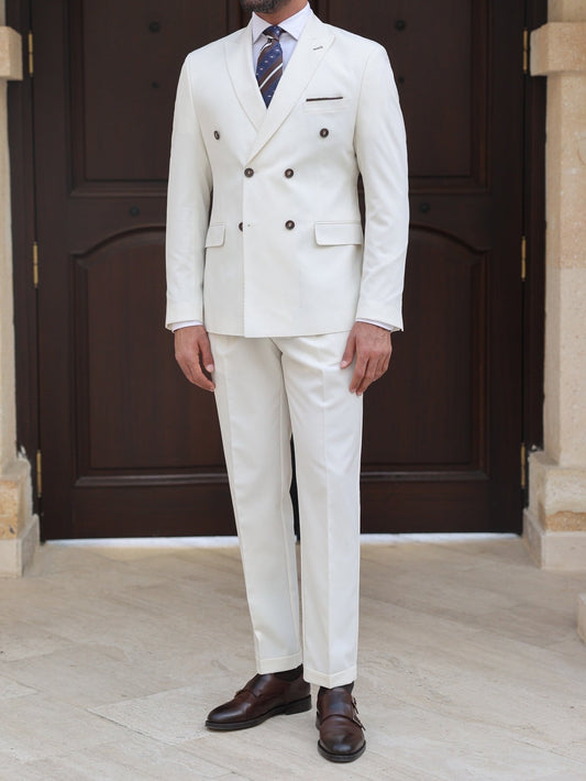 Men’s white double-breasted slim-fit suit with tailored trousers, styled with a dress shirt and tie for a clean, modern formal look.