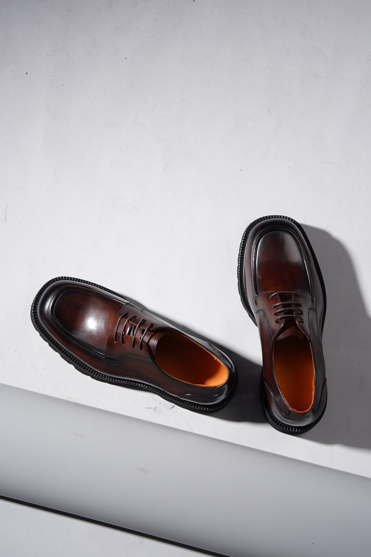 Pair of Luxury Brown Chunky Derby Shoes showing rugged sole and elegant hand-polished finish.