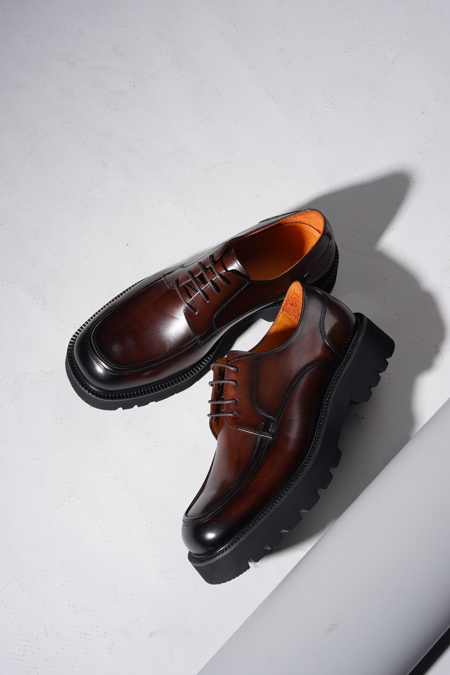Pair of Luxury Brown Chunky Derby Shoes showing rugged sole and elegant hand-polished finish.