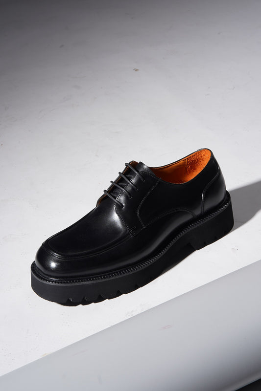 Pair of Luxury Chunky Derby Shoes angled to highlight chunky sole and polished leather upper.