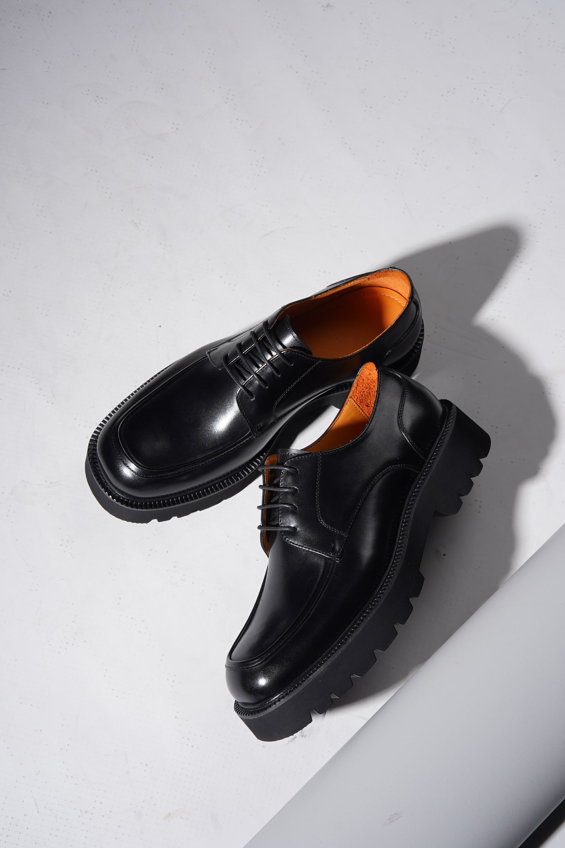 Pair of Luxury Chunky Derby Shoes angled to highlight chunky sole and polished leather upper.