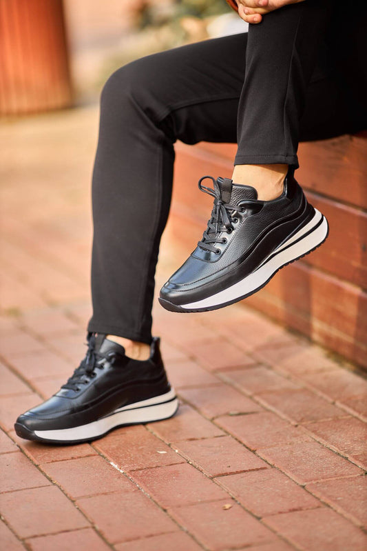 Men’s black leather elevated-sole sneakers on brick steps – premium casual footwear