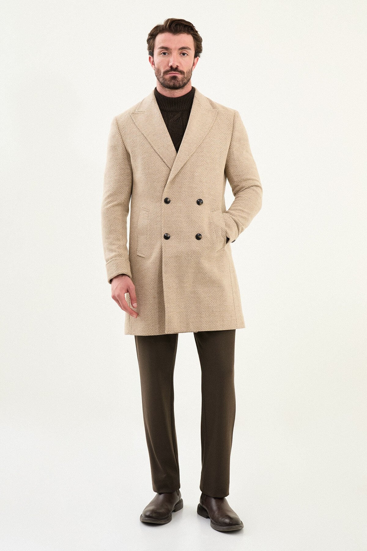 beige slim fit wide collar double-breasted coat, styled with a dark brown turtleneck sweater, front view.
